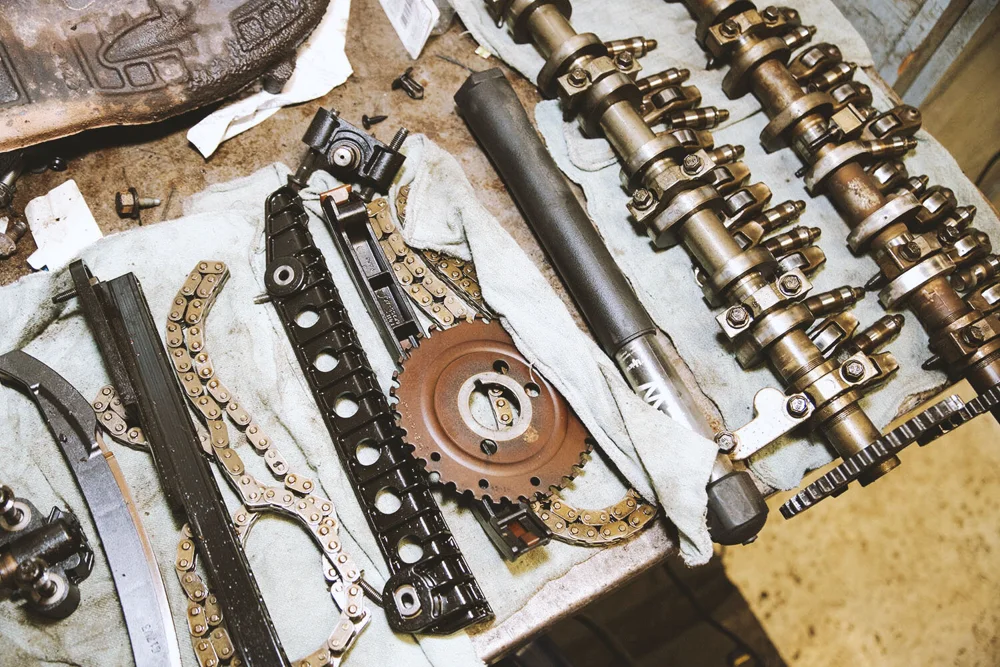 Camshafts, timing chains and sprockets laid out on shop towels at Carlson Auto.